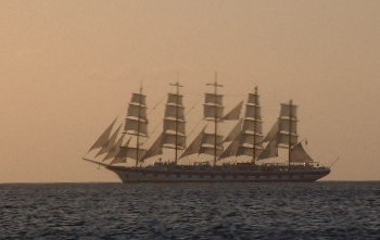 A beautiful 5-master setting sail in the sunset