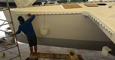 Akoosh sanding the new gelcoat on the starboard tramp holders