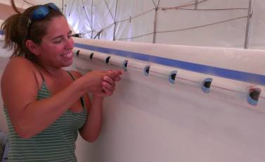 Amanda cutting the blue PVC out of the otherwise finished slots