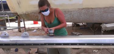 A very tanned Amanda polishes the mast