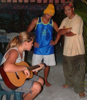 Amanda shows off her guitar style to the brothers