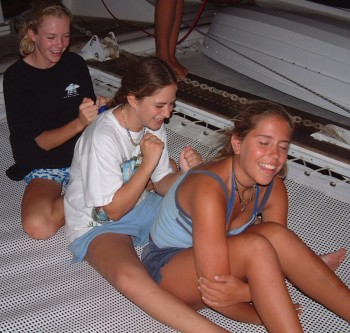 Girls giving each other back-rubs on Ocelot's trampolines