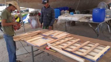 Baw and Heru prepare the slats for the hatches