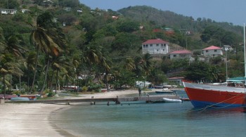 Bequia beach and the red bow of a wooden work boat