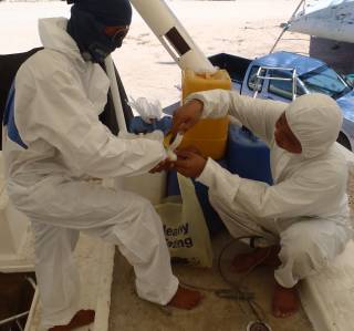 Max and Boy get suited up for grinding fiberglass