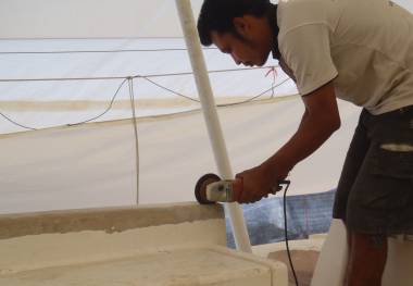 Boy cutting the top off the aft cockpit seat to remove the balsa