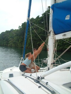 Amanda and Chris hoisting Ocelot's mainsail together