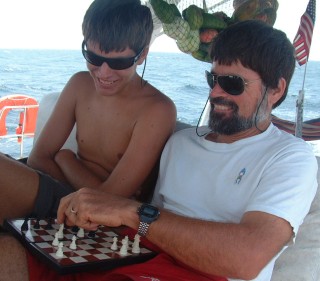 Playing chess on passage - note fruit net in background