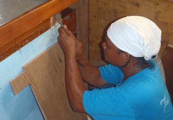 Houa fitting a piece of teak plywood into the galley