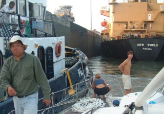 Amanda finishes cleating off the bow lines. Jimmy Wong, the advisor in front.