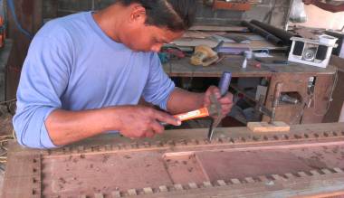 Houa working on the teak frame that will hold his teak lattice