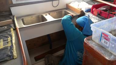 Houa fitting the sink on top of his new facade in the galley