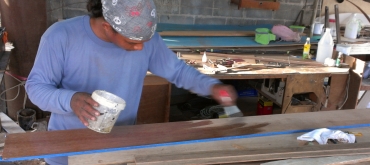 Houa applying epoxy sealer to his teak board for the salon