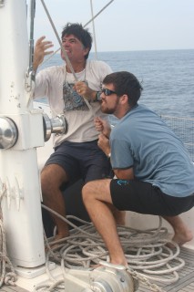 Jon & Chris raise the mainsail as we sail north to Thailand