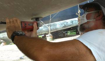 Grinding off old gelcoat from the bottom of the starboard hull