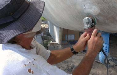 Grinding out thick fiberglass on the hull - a truly nasty job