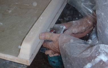 A plastic covered Jon using a router to round the bottom edge