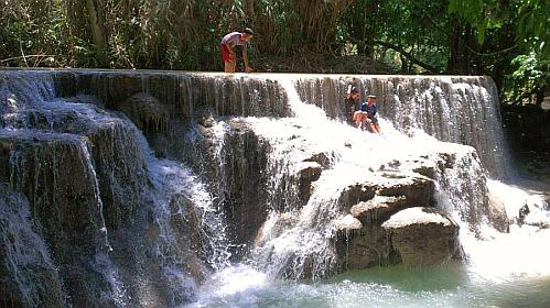 Kids playing in the wonderful Kuang Si Waterfalls