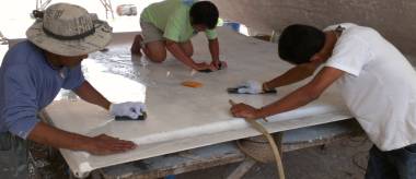 Lek, Song, & Baw wet-sanding the bimini under Ocelot