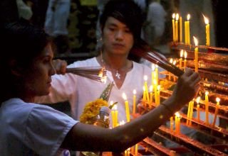 Lighting incense at Jui Tui Temple, Phuket Vegetarian Festival, Thailand