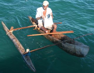 Madagascan lobsterman & dugout canoe