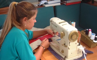 Sewing up the Australian flag before arrival