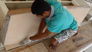 Max squooshing his strip of foam into the epoxy mud