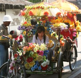 Flower-covered trishaws in Melaka