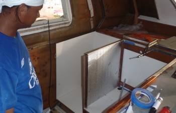 Houa examines the insulation & Formica he's installed