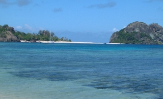 Navadra islands have black rocks and white beaches. Ocelot's mast is dwarfed