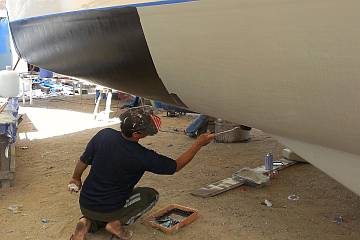 Pla rolling on the first coat of ablative Interswift antifouling