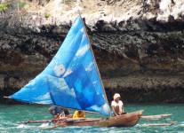 Papuan outrigger canoe under sail in Triton Bay