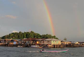 Almost beautiful. Sorong waterfront under a rainbow