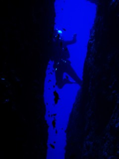 A diver highlighted on the far side of Split Rock
