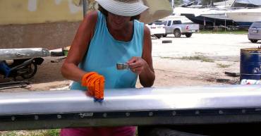 Sue applying Nyalic to the mast with a lint-free rag