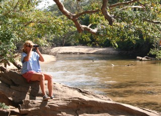 Sue birding by the river in Yala National Park