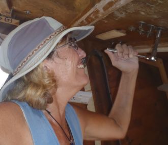 Sue removing winches from the cabin-top