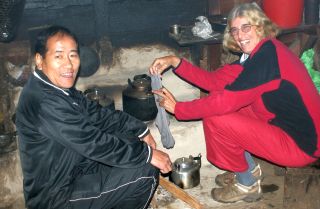 Thupten & Sue by family hearth, drying socks!
