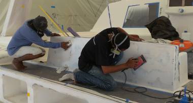 Yoong & Baw sanding the epoxy sealer on the aft cockpit seat