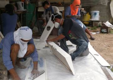 Our men sanding hatches, covers & etc in Houa's workshop